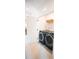 Convenient laundry room with modern, front-load washer and dryer set, plus a shelf for storage at 7936 Cedarsmith Ct, Charlotte, NC 28217