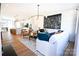 Open concept living room and kitchen with wood floors, modern lighting, and white sofa at 7936 Cedarsmith Ct, Charlotte, NC 28217