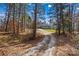 Long gravel driveway leads to beautiful grey home in a serene wooded setting at 825 Potneck Rd, Salisbury, NC 28147