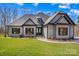 Charming single-story home with light-blue siding, black trim, lush green lawn, and a covered front entrance at 825 Potneck Rd, Salisbury, NC 28147