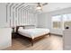 Modern bedroom with unique wall design, ceiling fan, and large windows at 8260 Waxhaw Hwy, Waxhaw, NC 28173