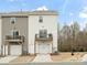 Two-story townhome featuring attached garage and wood balcony, with neutral vinyl siding at 8260 Waxhaw Hwy, Waxhaw, NC 28173