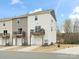 Two-story townhome featuring attached garage and wood balcony, with neutral vinyl siding at 8260 Waxhaw Hwy, Waxhaw, NC 28173