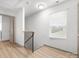Upstairs hallway with wood staircase and natural light at 8260 Waxhaw Hwy, Waxhaw, NC 28173