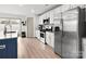 Bright kitchen features stainless steel appliances, white cabinetry and an island at 8260 Waxhaw Hwy, Waxhaw, NC 28173