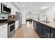 Well lit kitchen has stainless steel appliances and a center island with seating at 8260 Waxhaw Hwy, Waxhaw, NC 28173