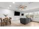 Bright living room with modern decor, ceiling fan, large windows, and stylish furnishings at 8260 Waxhaw Hwy, Waxhaw, NC 28173
