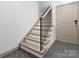 Modern staircase with wood steps and black metal railing at 8260 Waxhaw Hwy, Waxhaw, NC 28173