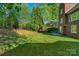Expansive backyard featuring lush green grass, mature trees, and a well-maintained lawn at 1119 Lytton Ln, Matthews, NC 28104