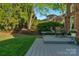 Private backyard featuring a cozy deck area, lush green lawn, and beautifully landscaped surroundings at 1119 Lytton Ln, Matthews, NC 28104