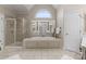 Bright bathroom features a tub, separate glass shower, tile flooring, and a vanity with a large mirror at 1119 Lytton Ln, Matthews, NC 28104
