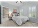 Bedroom with light-blue walls, carpet flooring, window with shutters, and a bed with gray pillows at 1119 Lytton Ln, Matthews, NC 28104
