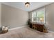 Bedroom with a window with blinds, a desk with a chair, and a plant in the corner at 1119 Lytton Ln, Matthews, NC 28104