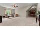 Spacious bonus room with a couch, ceiling fan, carpet, and a window providing ample light at 1119 Lytton Ln, Matthews, NC 28104