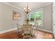 Breakfast area with table, chairs, chandelier, and a window showing view of the outdoors at 1119 Lytton Ln, Matthews, NC 28104
