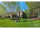 Charming brick home with a lush lawn and mature trees offering great curb appeal and a welcoming atmosphere at 1119 Lytton Ln, Matthews, NC 28104