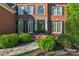 Charming brick home with a well-maintained lawn, manicured shrubs, and black window shutters at 1119 Lytton Ln, Matthews, NC 28104