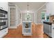 View of kitchen island, stainless steel appliances, white cabinets, and breakfast area at 1119 Lytton Ln, Matthews, NC 28104