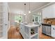 Kitchen with an island, stainless steel appliances, white cabinets, and a view of the breakfast area at 1119 Lytton Ln, Matthews, NC 28104