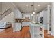 Bright kitchen features white cabinets, stainless steel appliances, kitchen island, and hardwood floors at 1119 Lytton Ln, Matthews, NC 28104
