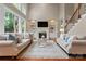 Inviting living room with built-in bookshelves, a cozy fireplace, and large windows at 1119 Lytton Ln, Matthews, NC 28104
