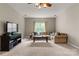 Inviting living room featuring plush carpeting, natural light, and a comfortable, oversized sectional sofa at 1119 Lytton Ln, Matthews, NC 28104