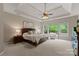 Main bedroom suite with a tray ceiling, ceiling fan, and large windows for natural light at 1119 Lytton Ln, Matthews, NC 28104