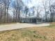 Charming one-story home with a metal roof, baby-blue door, brick facade, and a covered carport at 112 Greentree Dr, Mount Holly, NC 28120