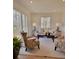 Bright living room featuring large windows, neutral color palette, and comfortable seating arrangement at 112 Greentree Dr, Mount Holly, NC 28120