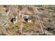 Aerial view of a home on a large, wooded lot with neighboring houses nearby at 126 Orville Rd, Statesville, NC 28677