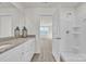 Bathroom featuring granite countertop vanity, and a shower/tub with a glass door at 126 Orville Rd, Statesville, NC 28677