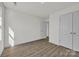 This bedroom features light-colored walls, wood-look flooring, and a double-door closet at 126 Orville Rd, Statesville, NC 28677