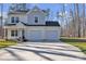 Two-story home with grey and white siding, a two-car garage, and an expansive driveway at 126 Orville Rd, Statesville, NC 28677