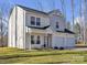 Charming two-story home featuring a welcoming porch, well-maintained lawn, and attached two-car garage at 126 Orville Rd, Statesville, NC 28677