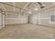 Spacious unfinished garage with an automatic door, electric panel, and water heater at 126 Orville Rd, Statesville, NC 28677