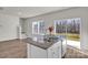 Kitchen island with granite countertop, stainless steel sink, and a sliding glass door leading to the backyard at 126 Orville Rd, Statesville, NC 28677