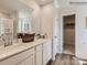 Bathroom featuring a double vanity, framed mirrors, and hardwood floors at 13011 Hampton Bay Ln, Charlotte, NC 28262