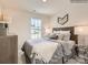 Cozy bedroom with stylish decor, a patterned bedspread, and ample lighting at 13011 Hampton Bay Ln, Charlotte, NC 28262