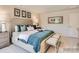 A cozy main bedroom features an upholstered bed, comfortable seating, and sophisticated decorative elements at 13011 Hampton Bay Ln, Charlotte, NC 28262