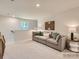 This living room features a comfortable gray sectional and a decorative wooden wall hanging at 13337 Hampton Bay Ln, Charlotte, NC 28262