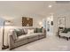 This living room includes a comfortable gray sofa, and a decorative wooden wall hanging at 13337 Hampton Bay Ln, Charlotte, NC 28262