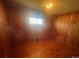 Wood-paneled bedroom with hardwood floors and a large window at 1403 Oakwood Ave, Kannapolis, NC 28081