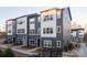 Exterior view of modern townhouses with a neutral color scheme, showcasing a contemporary design and well-maintained landscaping at 1518 Levy Way, Charlotte, NC 28205