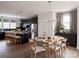 Open-concept kitchen and dining area with dark cabinets, a dining table set, and lots of natural light at 1518 Levy Way, Charlotte, NC 28205