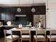 Modern kitchen with dark cabinets, a bright white countertop island with seating, and stainless steel refrigerator at 1518 Levy Way, Charlotte, NC 28205