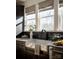 Charming kitchen with a farmhouse sink, black backsplash, modern faucet, and ample natural light at 1518 Levy Way, Charlotte, NC 28205