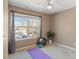 Bedroom featuring a ceiling fan, workout equipment, and a large window at 154 Limerick Rd # D, Mooresville, NC 28115