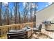 Outdoor deck with seating, a table, and a grill, surrounded by trees at 154 Limerick Rd # D, Mooresville, NC 28115