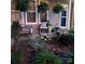 Inviting front porch with chairs, hanging ferns, and lush landscaping creating a welcoming entrance at 154 Limerick Rd # D, Mooresville, NC 28115