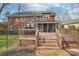 Large brick home with multiple outdoor spaces, including a deck and screened porch at 1916 Dugan Dr, Charlotte, NC 28270